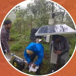 Researchers installing equipment in the rain