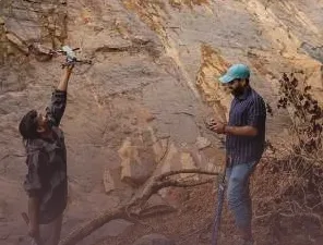 Amrita researchers surveying a landslide site with a drone